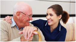 Caregiver smiling with an older man at home
